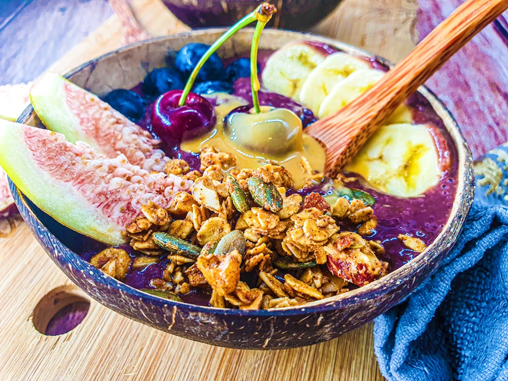 Vegan Recipes Cacao-Shamaness Vegan Acai Smoothie Bowl with Fresh Fruits, Homemade Granola, and Organic Peanut Butter.