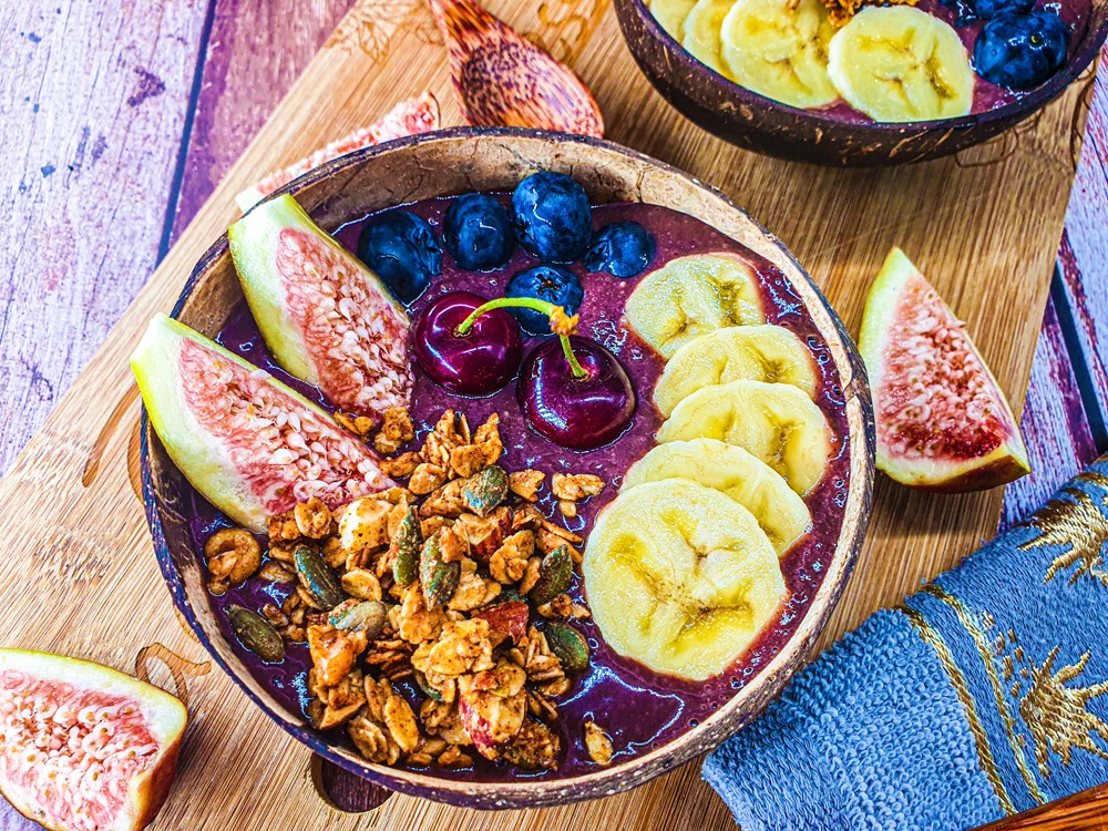 Vegan Recipes Cacao-Shamaness Vegan Acai Smoothie Bowl with Fresh Fruits, Homemade Granola, and Organic Peanut Butter.